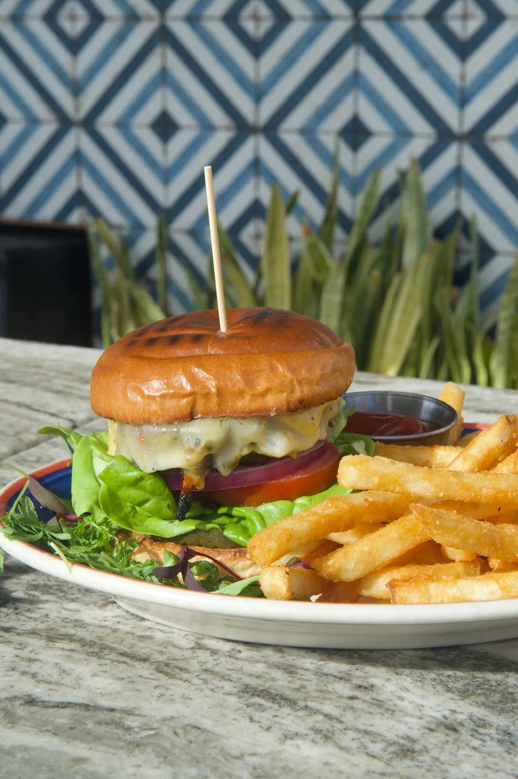 Miss B's Burger with cheese, lettuce, tomato, and fries