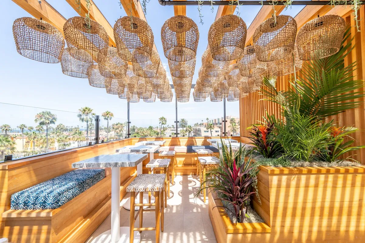 Coco Cabana cabana interior with rattan pendant lamps and tropical plants