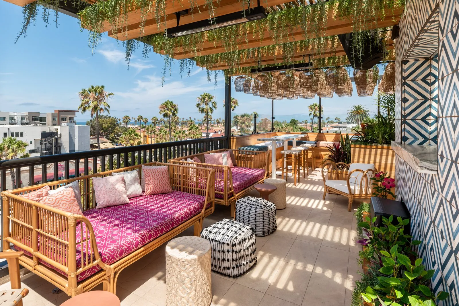 Coco Cabana rooftop lounge seating with rattan pendants, tile wall, and Oceanside views